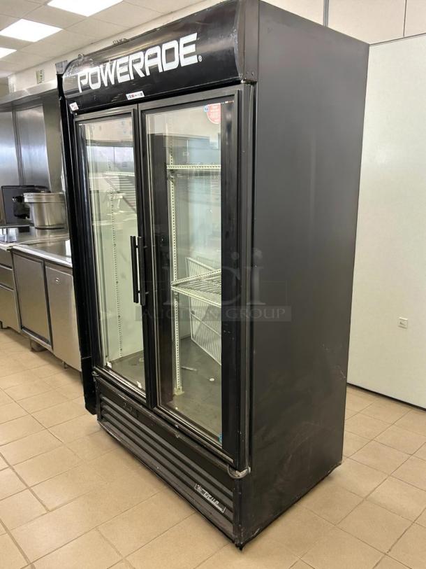 True GDM-43-HC glass door merchandiser, black, 47 1/8", two sections, tested, working, left/right hinge doors, Powerade sign.