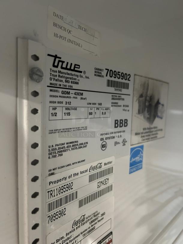 True GDM-43-HC~TSL01 glass door merchandiser label, showing model GDM-43EM, 115V, serial number 7095902, Energy Star certified.