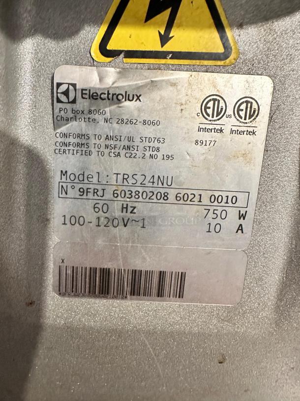 Electrolux TRS24NU food processor tag showing model, voltage, certification info, and Intertek labels. 