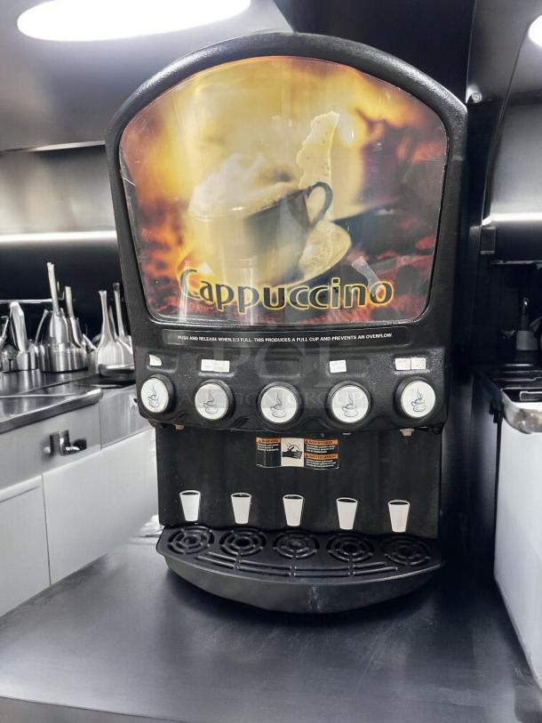 Grindmaster PIC5 cappuccino and beverage dispenser, five-flavor, great condition, fully tested, 120V, black unit with selection buttons.