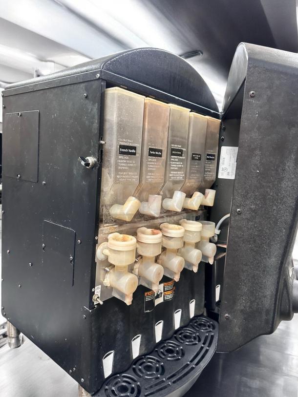 Grindmaster PIC5 beverage dispenser, five flavors, great condition, tested, black exterior, visible labels, 120V.