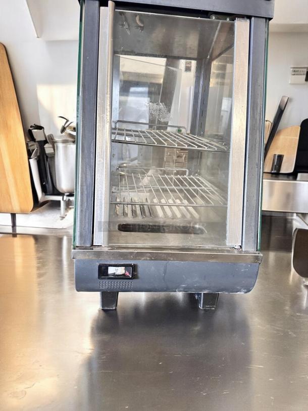 Winco HDM-13 heated display merchandiser in outstanding condition, with glass panels, shelves, and temperature dial, fully tested.