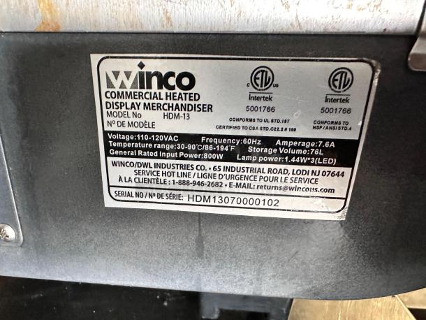 Winco HDM-13 commercial heated display merchandiser label, showing voltage, temperature range, and certification details.