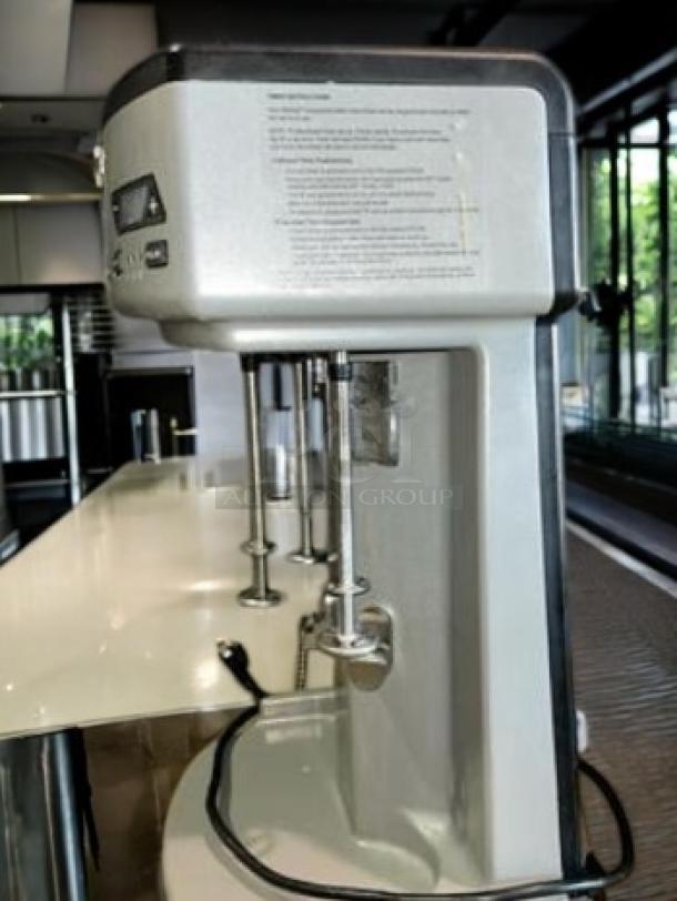 Waring WDM360TX triple-spindle drink mixer in pristine condition, 120V. Visible label with operational details.