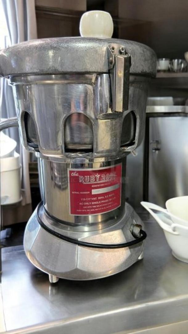 Ruby 2000 heavy-duty commercial juice extractor, 115V, stainless steel, fully tested, excellent condition; red label with model info.