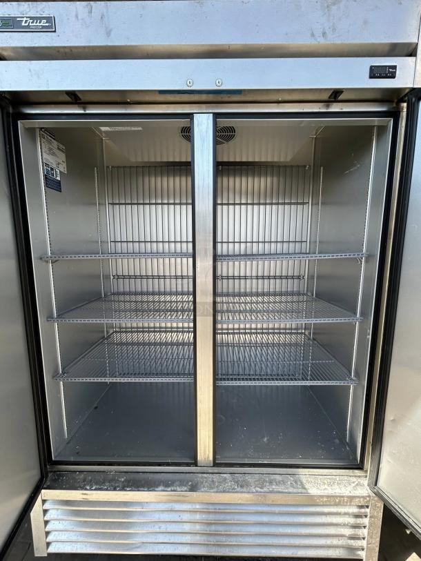 Superb condition True T-49F-HC 2-door reach-in freezer, 115V, stainless steel interior, fully tested, spacious shelving.