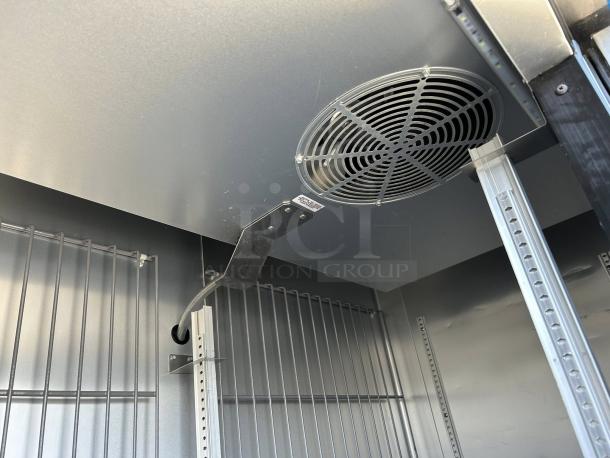 Interior view of True T-49F-HC 2-Door Reach-In Freezer, superb condition, featuring shelves and cooling fan.