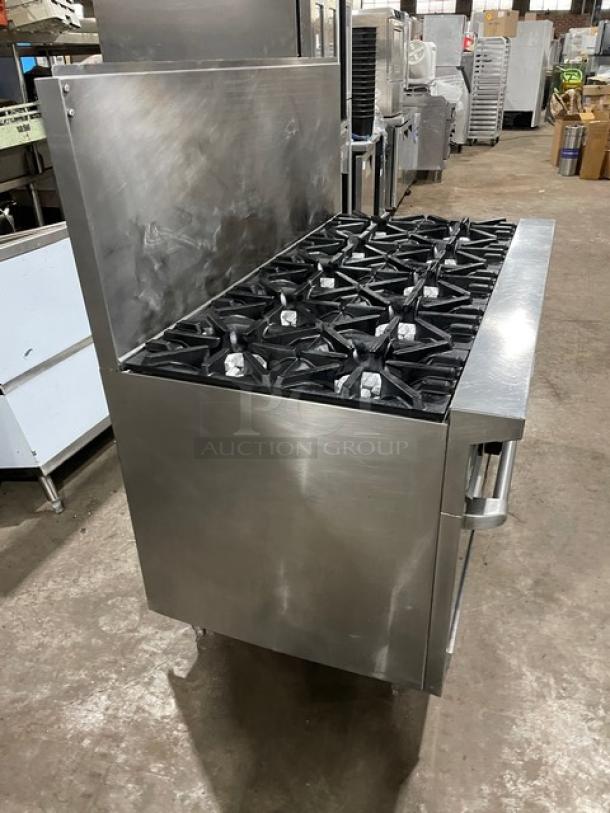 U.S. Range commercial stainless steel 10-burner natural gas range with double oven, backsplash, wired oven rack, on legs.