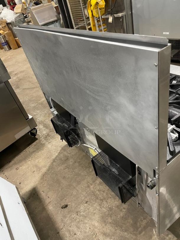 U.S. Range stainless steel 10-burner range with double oven, back splash, wired oven rack, on legs, natural gas powered.