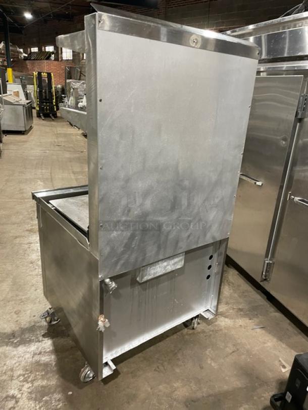 Jade Range commercial stainless steel 36" flat top range/oven combo. Features back splash, double overhead shelf, and casters.