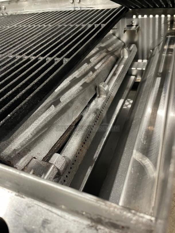 Therma-Tek stainless steel countertop char broiler, natural gas powered, with back and side splash, on legs.