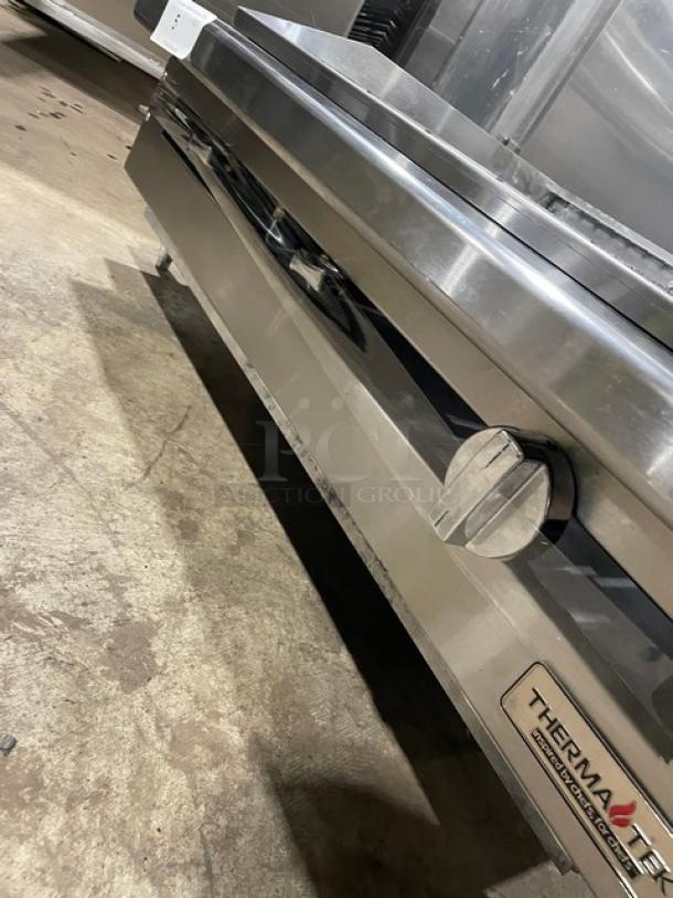 Therma-Tek stainless steel countertop char broiler with back and side splash, on legs, natural gas powered.