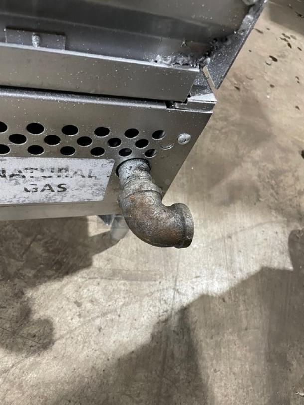 Therma-Tek stainless steel natural gas char broiler with back and side splash, on legs, showing gas connection detail.