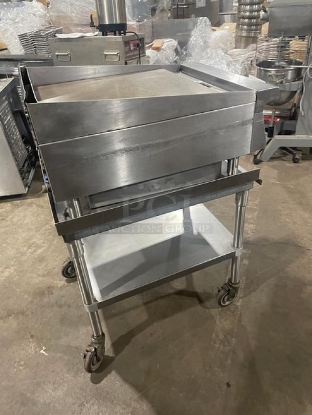 Garland stainless steel countertop flat griddle with thermostatic control, back and side splash, on legs, with caster-mounted BK Resource undershelf stand.