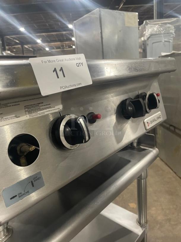 Garland stainless steel natural gas countertop griddle with thermostatic control, back & side splash. On undershelf stand with casters.