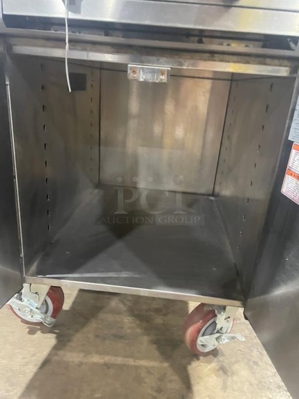 Vulcan VCBB24B char broiler range with stainless steel cabinet, dry storage base, backsplash, and salamander shelf on casters.