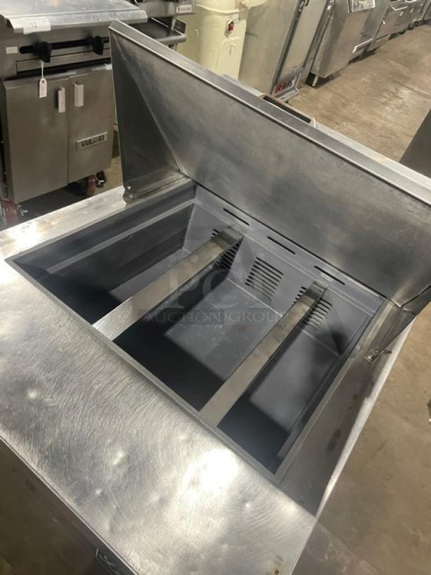 Leader stainless steel refrigerated prep table, Model NSFM27. Features single door, poly coated rack, on casters, 115V.