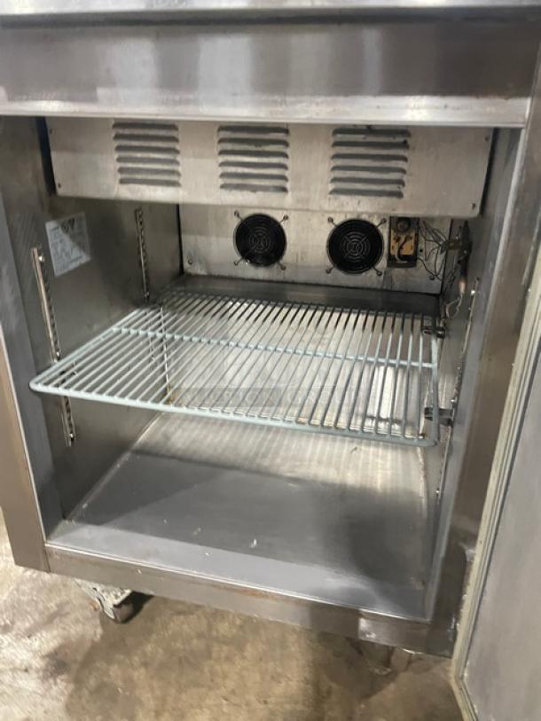 Leader Commercial Stainless Steel Single Door Refrigerated Prep Table, Model NSFM27. Features poly-coated wired rack, 115V, on casters.