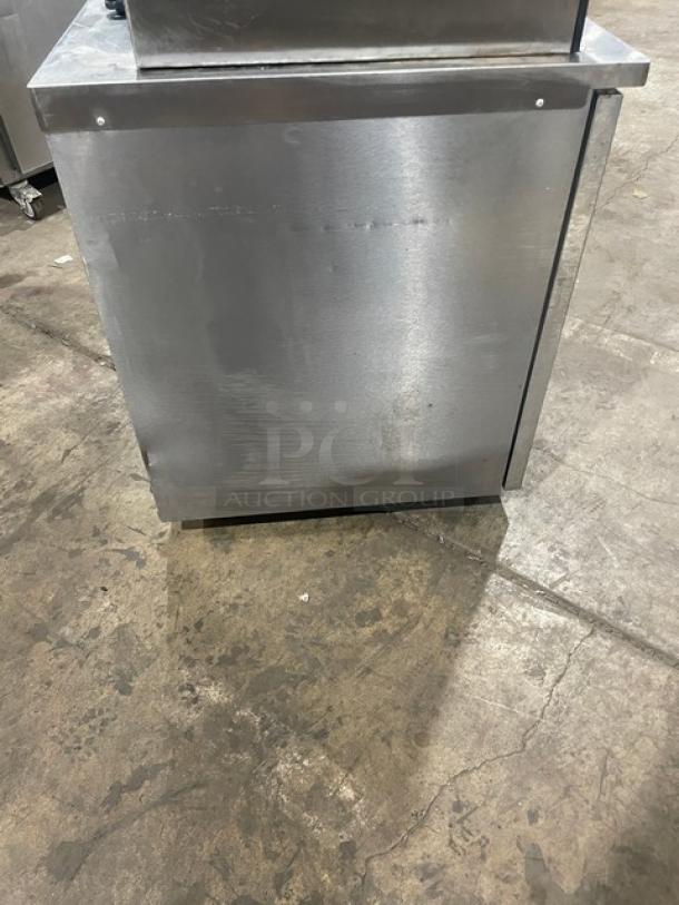 Delfield Enodis Series stainless steel undercounter refrigerator, model 406-STAR2, single door, on casters, with poly-coated rack.