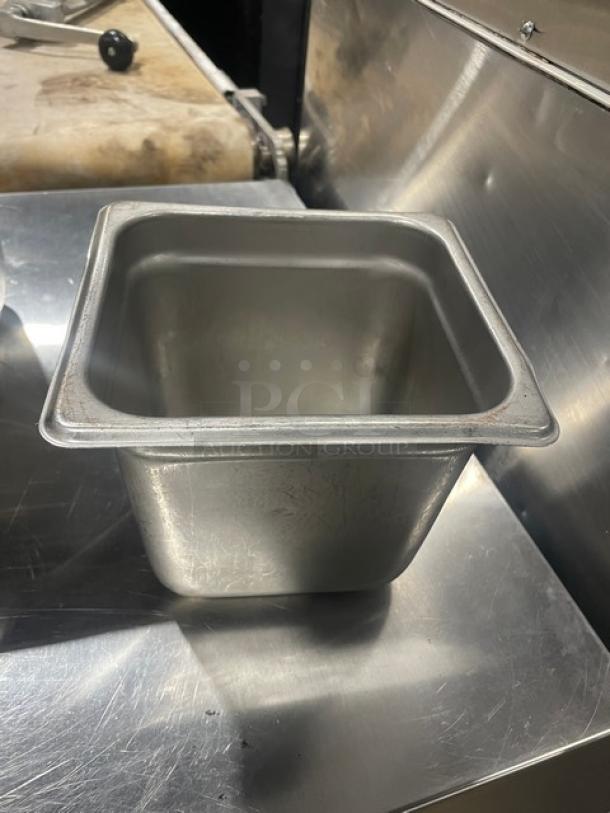 Commercial stainless steel steamtable pan, square shape, good condition, used in hotels. Durable food-grade material.