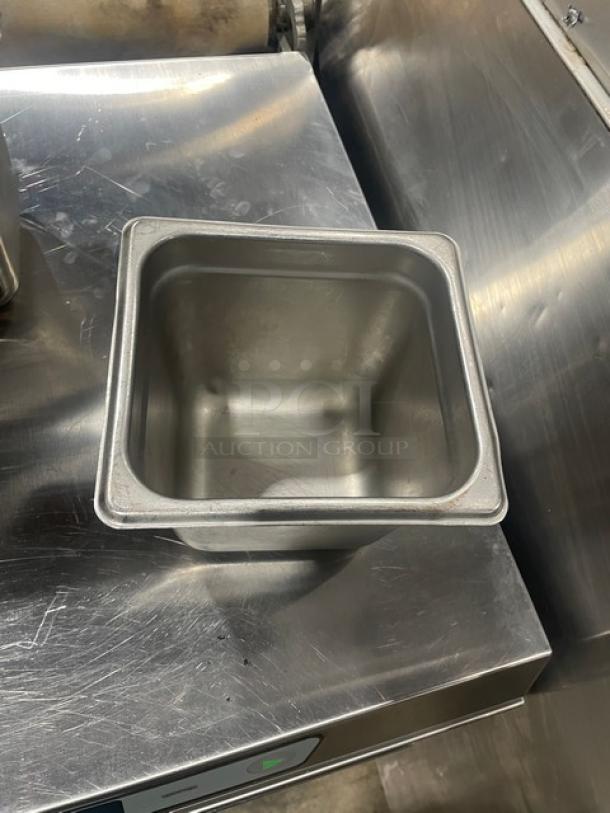 Commercial stainless steel hotel steamtable pan, square shape, polished finish, good condition, visible surface markings.