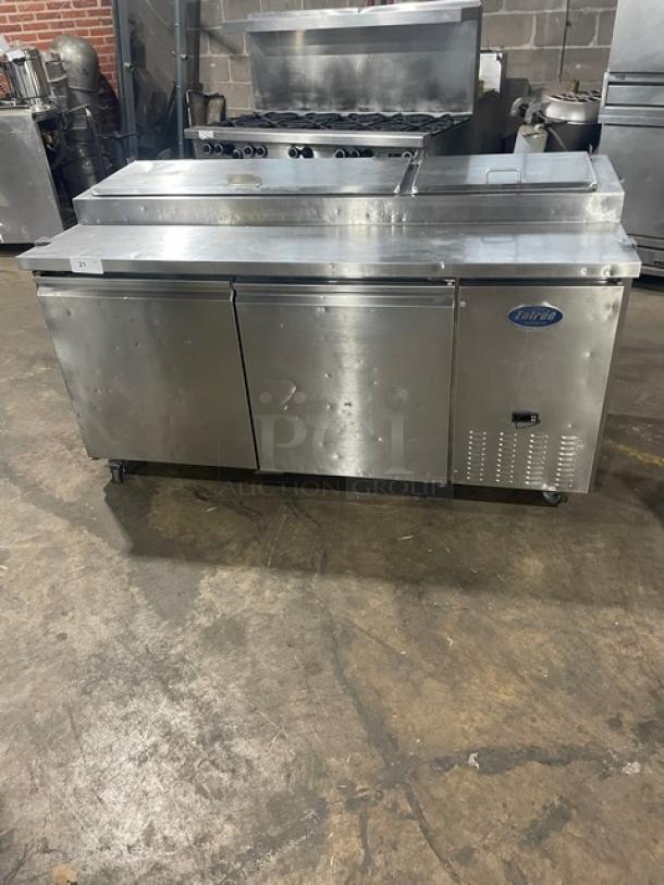 Entree stainless steel 2-door refrigerated Bain Marie pizza prep table, model P70, with poly coated rack, on casters.