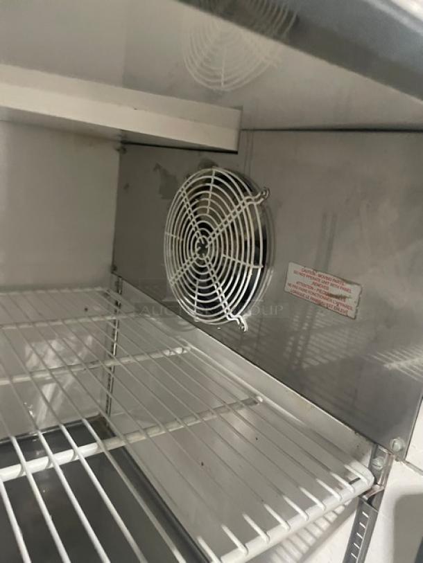 Entree P70 stainless steel 2-door refrigerated bain marie style pizza prep table with poly-coated wired rack, on casters.