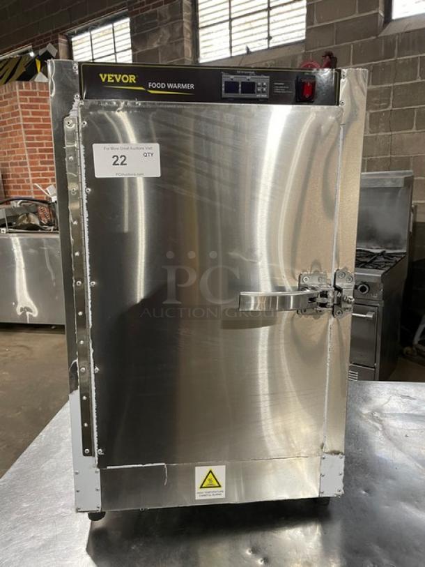 Vevor stainless steel countertop food warmer with digital controls, on legs. Features brand label and a safety warning tag.