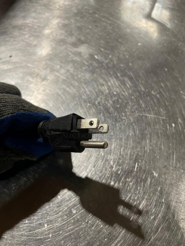 Close-up of a three-prong electrical plug attached to the Vevor Commercial Electric Food Warmer.
