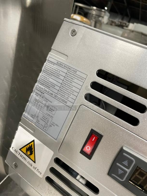 Marchia MSU140S stainless steel sushi display, serial number 1301302100045, with on/off switch and caution label visible.