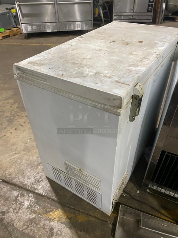 Haier commercial white chest freezer, model HE71CL53NW, with top hinged lid. Used condition, works when removed.