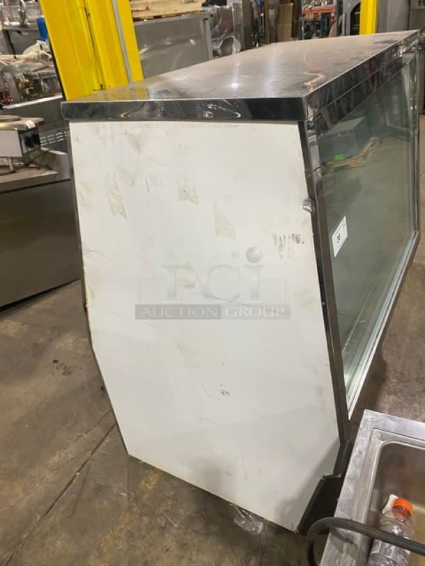 Custom Cool stainless steel deli merchandiser model DEL4SC with slanted glass, double sliding doors, and lower storage.