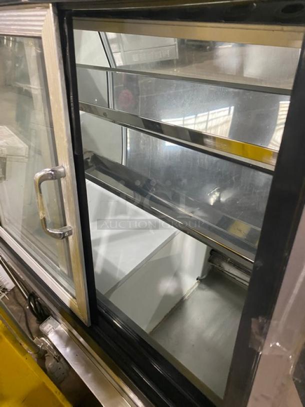 Custom Cool stainless steel refrigerated deli display, model DEL4SC, with slanted glass, double sliding doors, and lower storage.