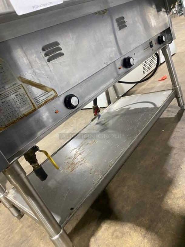 Eagle Group stainless steel 3-well electric hot food/steam table with tray slide, undershelf, and legs. Slight wear visible.