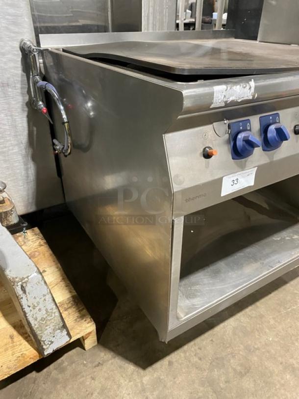 Electrolux Thermaline stainless steel flat top grill, natural gas, enclosed base, on legs, features dial controls, model label visible.