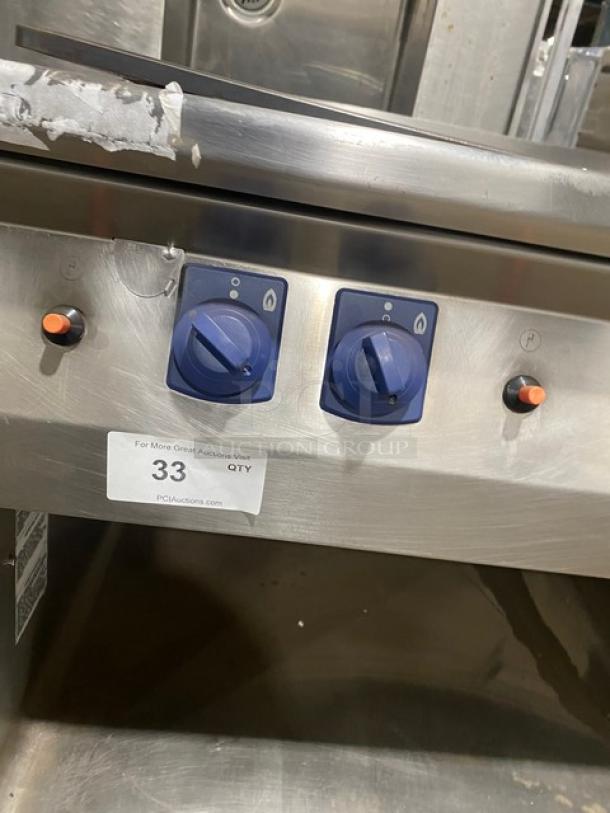Electrolux Thermaline stainless steel flat top grill with enclosed base, natural gas, commercial use, visible control knobs.