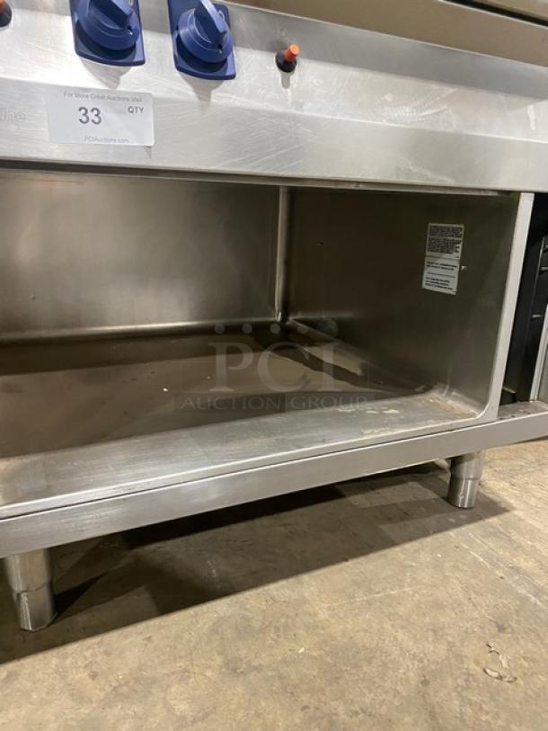 Electrolux Thermaline stainless steel gas grill with enclosed open base, blue knobs, on legs, used condition.