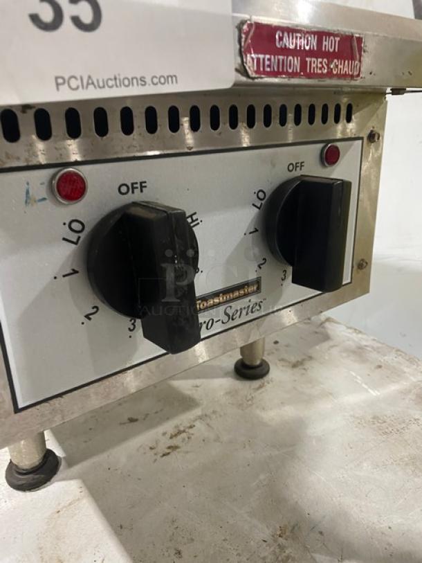 Toastmaster Pro-Series 2-Burner Hot Plate Range, Model THPF. Stainless steel, front controls, caution label visible.