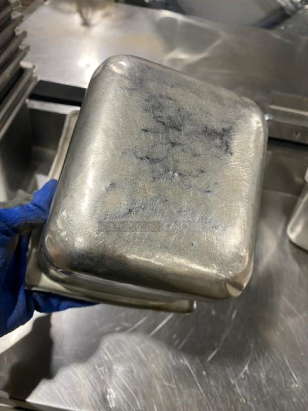 Commercial stainless steel steamtable pan in used condition, visible wear marks, ideal for hotel kitchen use.