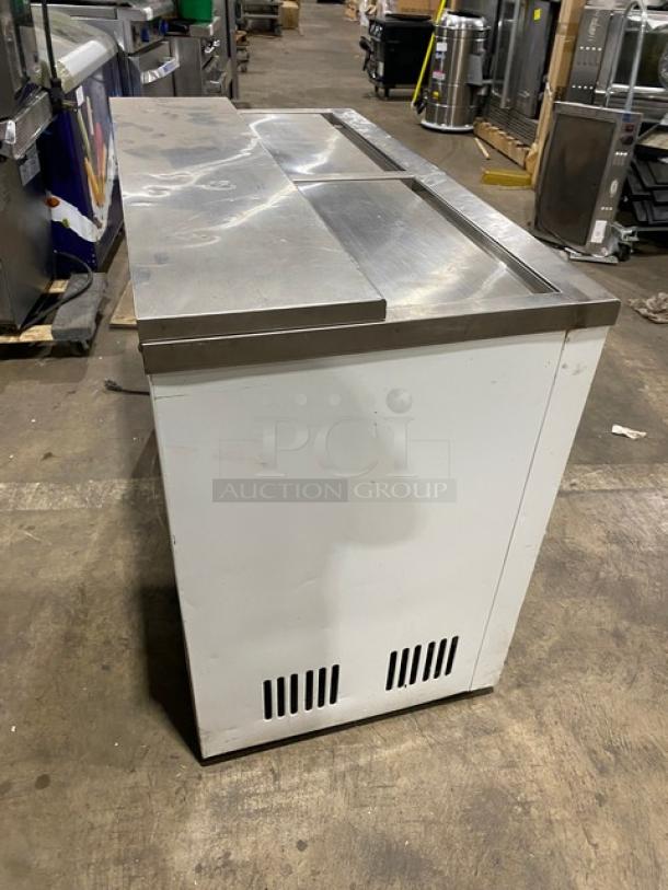 Summit SCFR100MAN 44" white back bar chest cooler, manual defrost, with double stainless steel sliding lids, on legs.