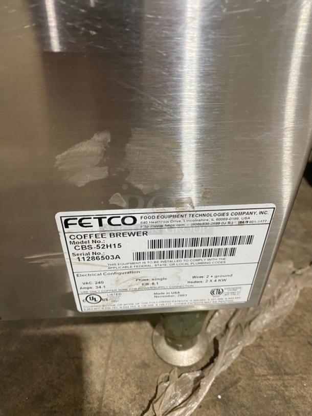 Fetco CBS-52H15 commercial twin coffee brewer, stainless steel, with hot water dispenser and visible model label.