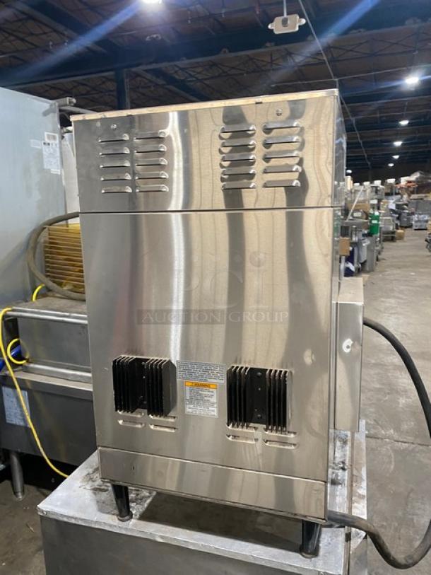 Bunn DUALSHDBC commercial stainless steel twin coffee brewer with digital control and hot water dispenser, on legs.