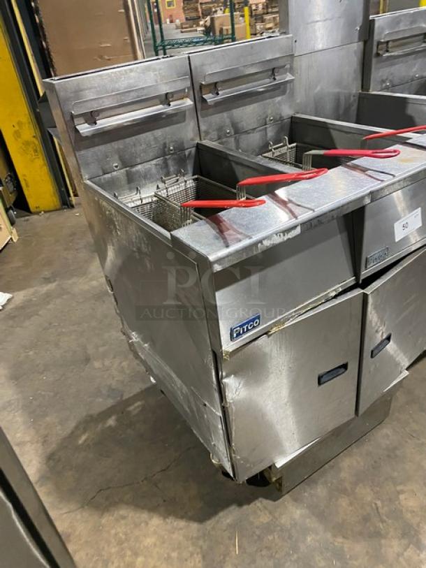 Pitco FGSGH50 4-bay deep fryer system, stainless steel, natural gas, with basket hangers and oil filter, on casters.