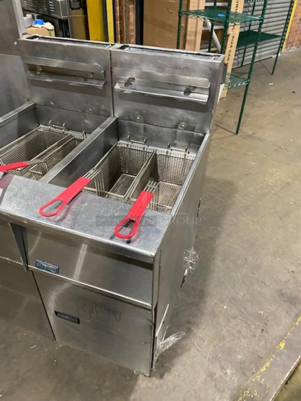 Pitco FG-SGH50 stainless steel 4-bay fryer with basket hanger, oil filter, and backsplash, on casters.