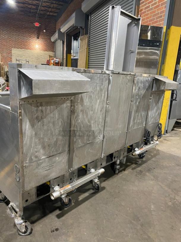 Pitco FGSGH50 commercial stainless steel 4-bay deep fryer with center basket hanger, backsplash, fry basket, and oil filter.