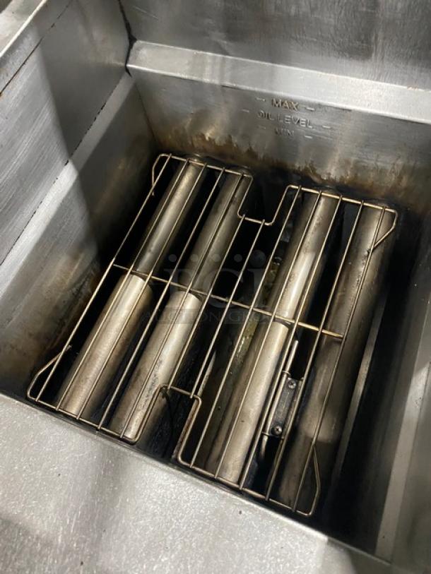 Pitco FGSGH50 4-bay stainless steel deep fryer, natural gas, center basket hanger, oil filter, on casters, used condition.
