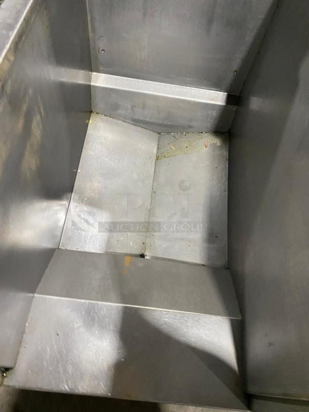 Pitco FGSGH50 stainless steel deep fryer interior, showing used condition. Features four bays, center basket hanger, and oil filter.