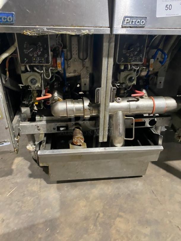 Pitco FGSGH50 commercial 4-bay fryer system, stainless steel, natural gas, with center basket hanger, backsplash, and oil filter, on casters.