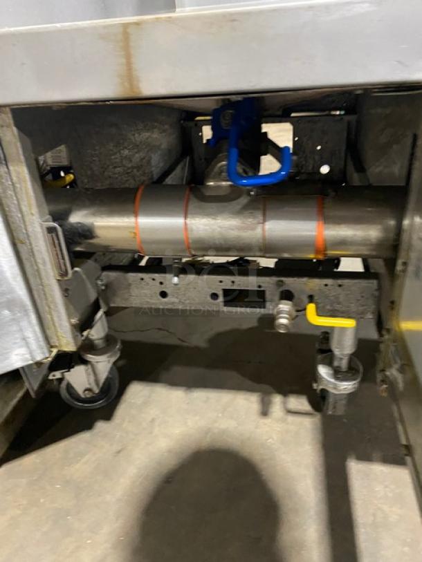 Pitco FGSGH50 4-bay deep fryer system. Stainless steel, natural gas, 50 lb capacity, on casters. Includes oil filter.