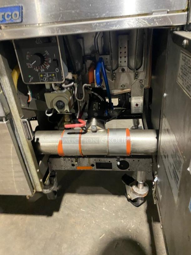 Pitco FG-SGH50 commercial stainless steel 4-bay fryer system interior, showing gas components and control panel; on casters.